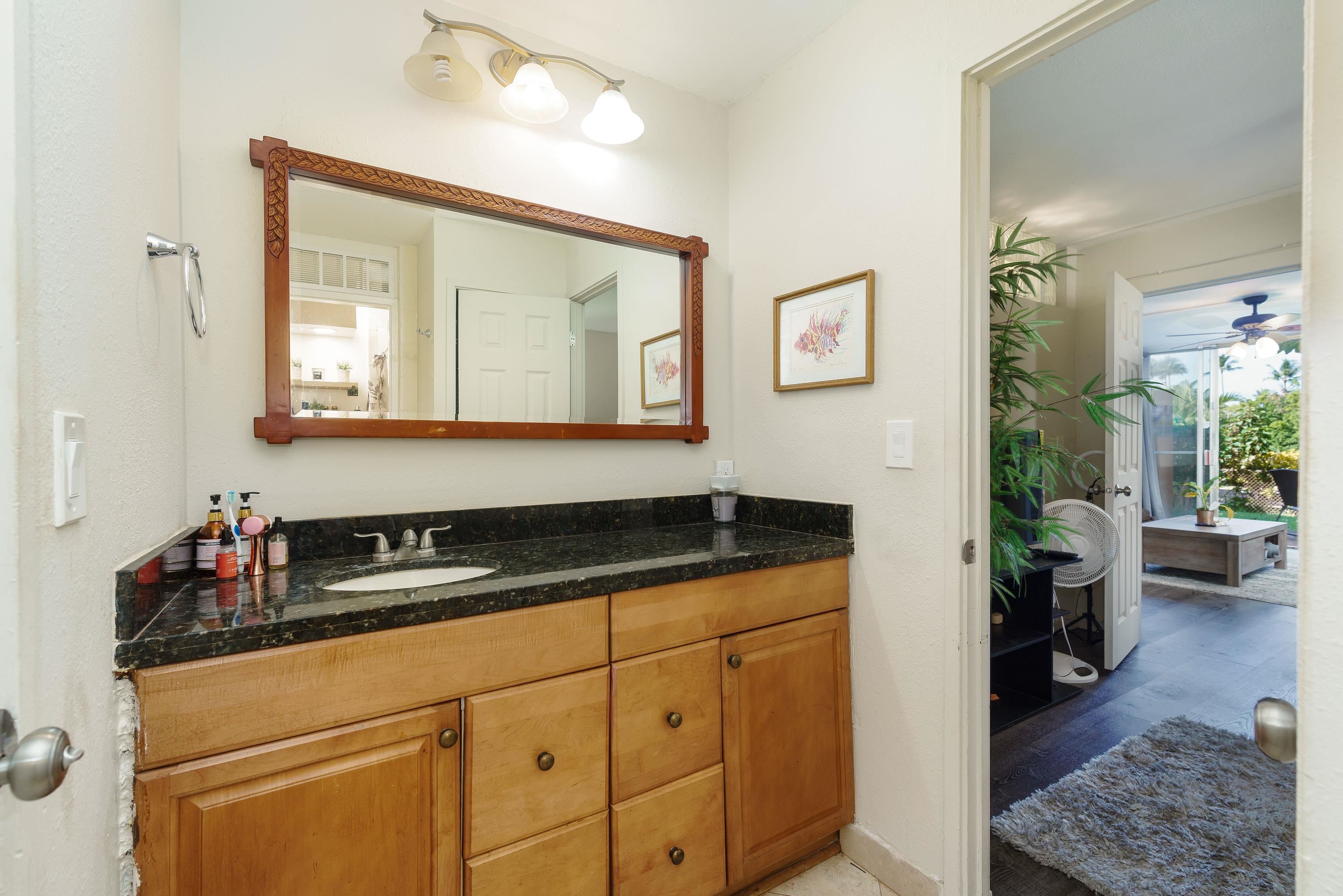3660 Lower Honoapiilani Road, Unit 111 Lahaina, HI 96761 - Photo 12 of 28 a kitchen with a sink and cabinets