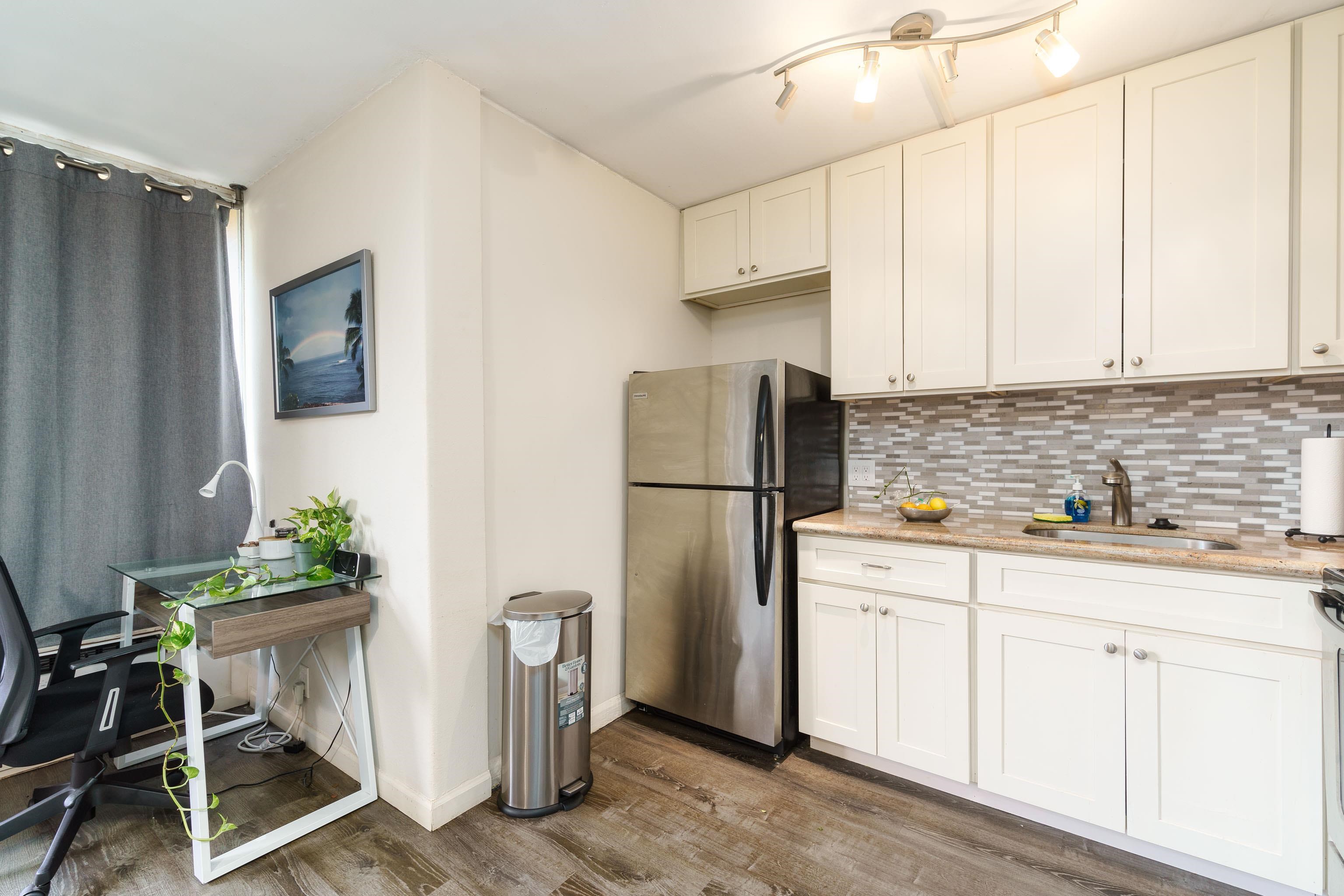 3660 Lower Honoapiilani Road, Unit 111 Lahaina, HI 96761 - Photo 2 of 28 a kitchen with stainless steel appliances a refrigerator a sink a stove a table and chairs