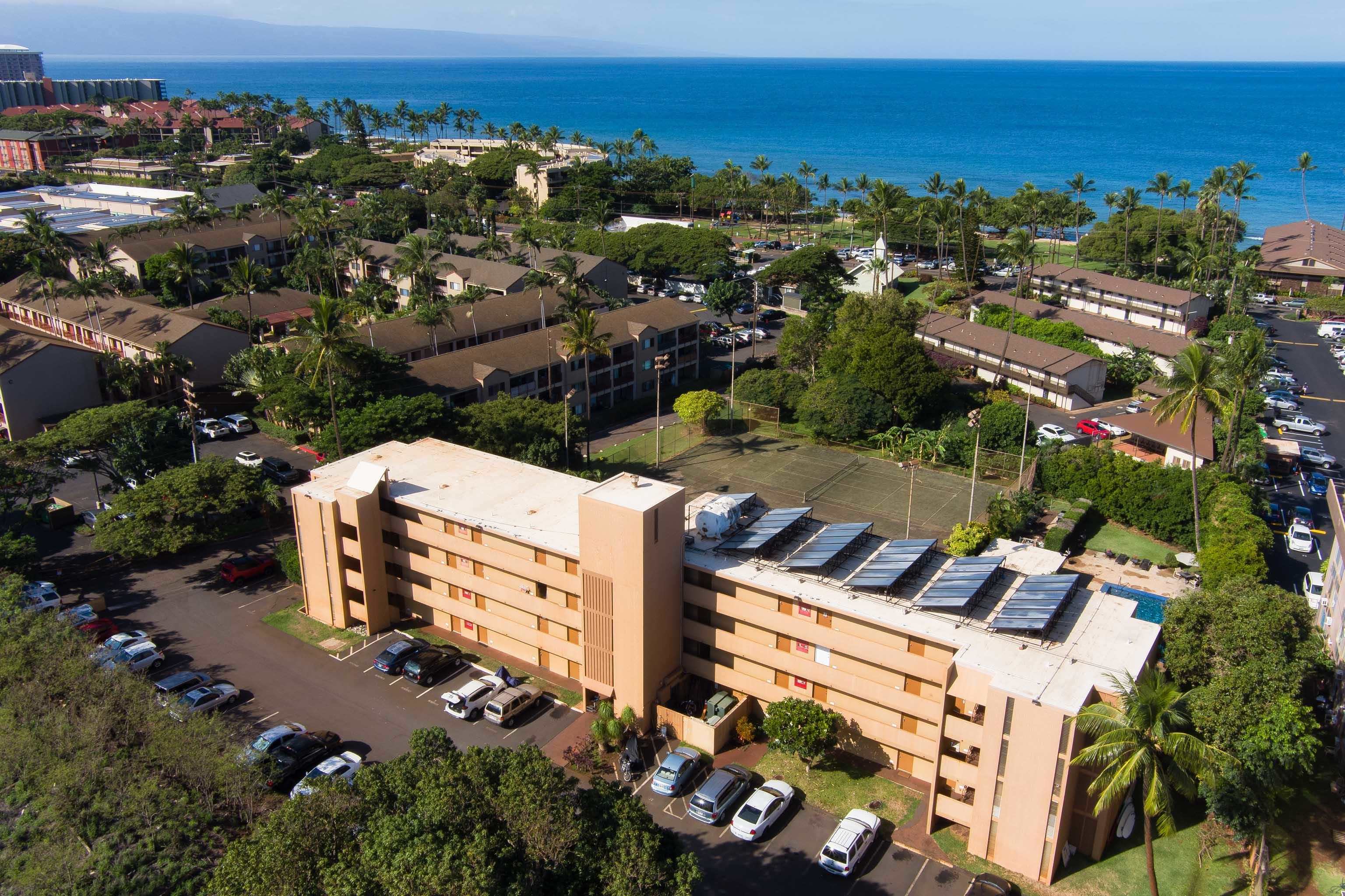 3660 Lower Honoapiilani Road, Unit 111 Lahaina, HI 96761 - Photo 24 of 28 an aerial view of multiple houses with yard
