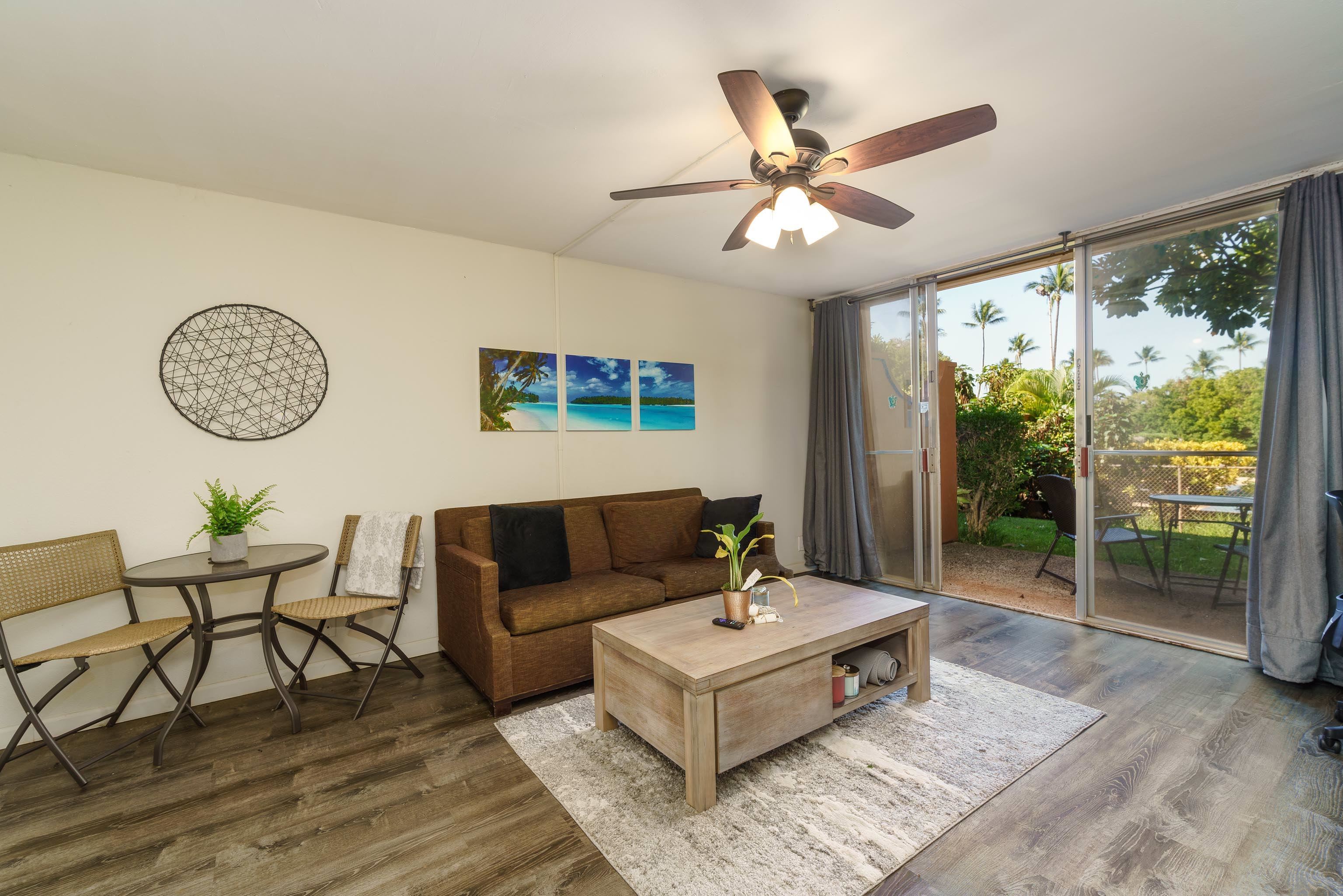 3660 Lower Honoapiilani Road, Unit 111 Lahaina, HI 96761 - Photo 6 of 28 a living room with furniture and a large window