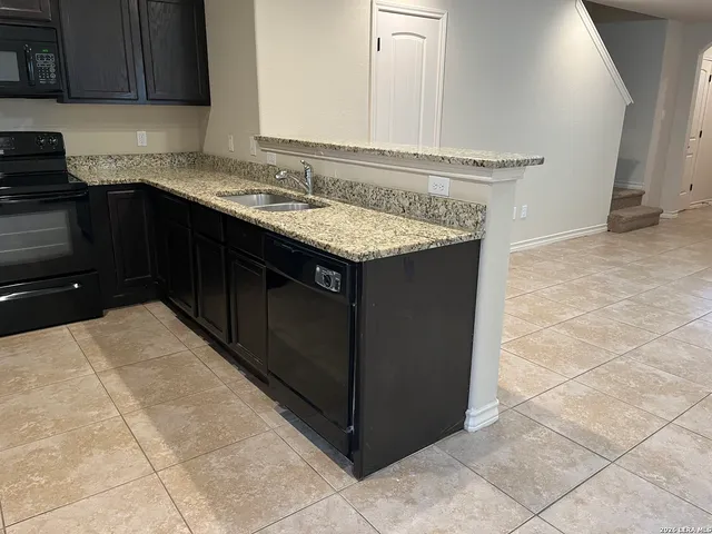 a kitchen with a refrigerator and a stove