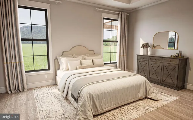 a bedroom with a bed and a dresser with mirror