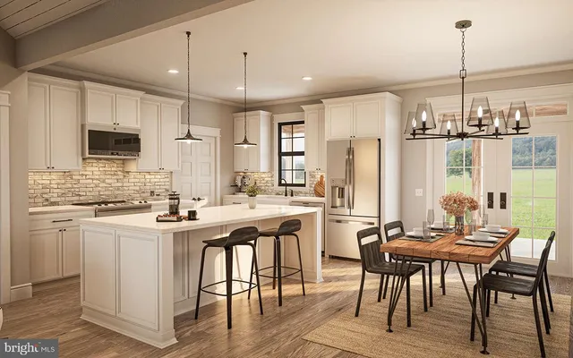 a kitchen with stainless steel appliances granite countertop a stove top oven a refrigerator a sink and white cabinets