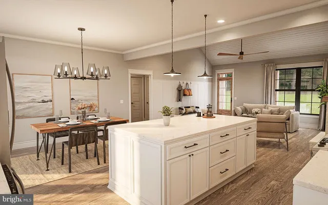 a kitchen with kitchen island a stove a chandelier and a dining table