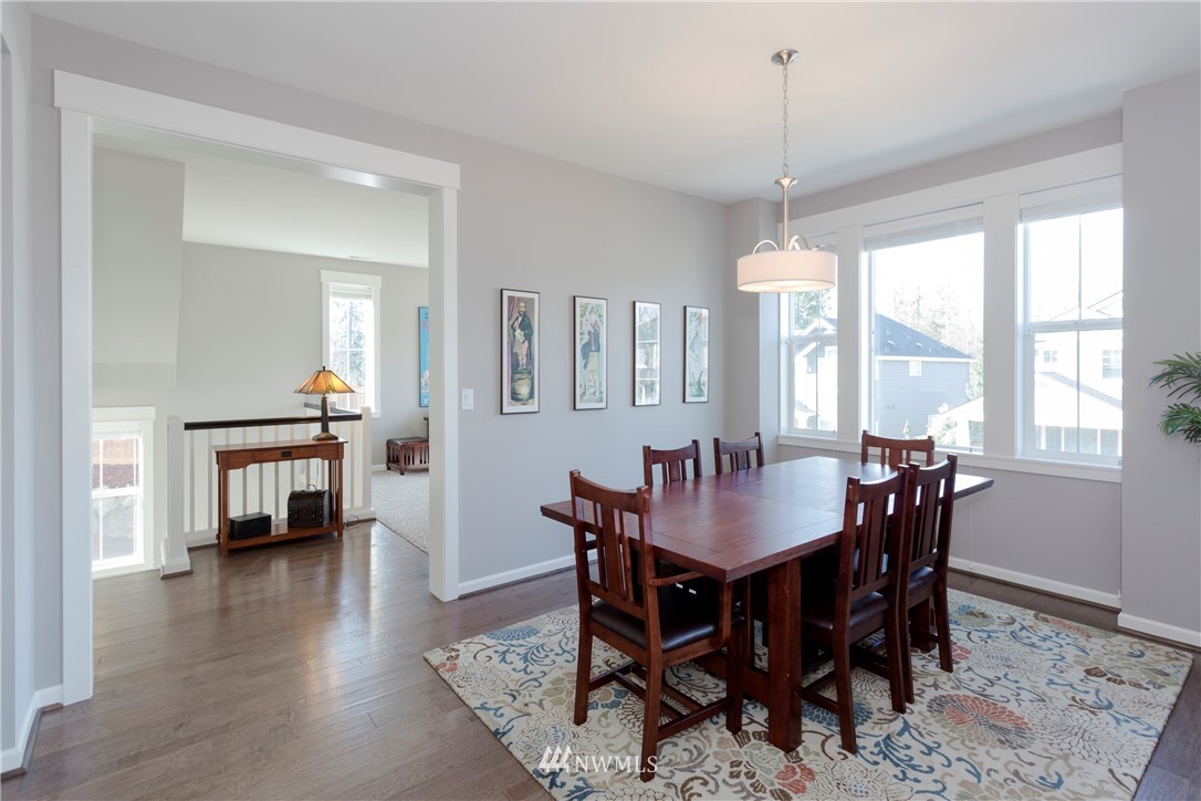 762 Lyons Avenue Northeast Renton, WA 98059 - Photo 13 of 33 a dining room with furniture window and wooden floor
