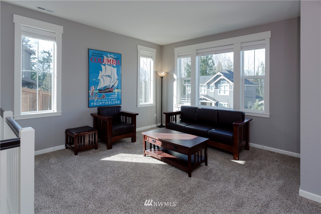 762 Lyons Avenue Northeast Renton, WA 98059 - Photo 14 of 33 a living room with furniture a fireplace and a window