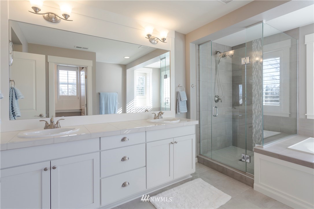 762 Lyons Avenue Northeast Renton, WA 98059 - Photo 20 of 33 a spacious bathroom with double sink a shower and a mirror