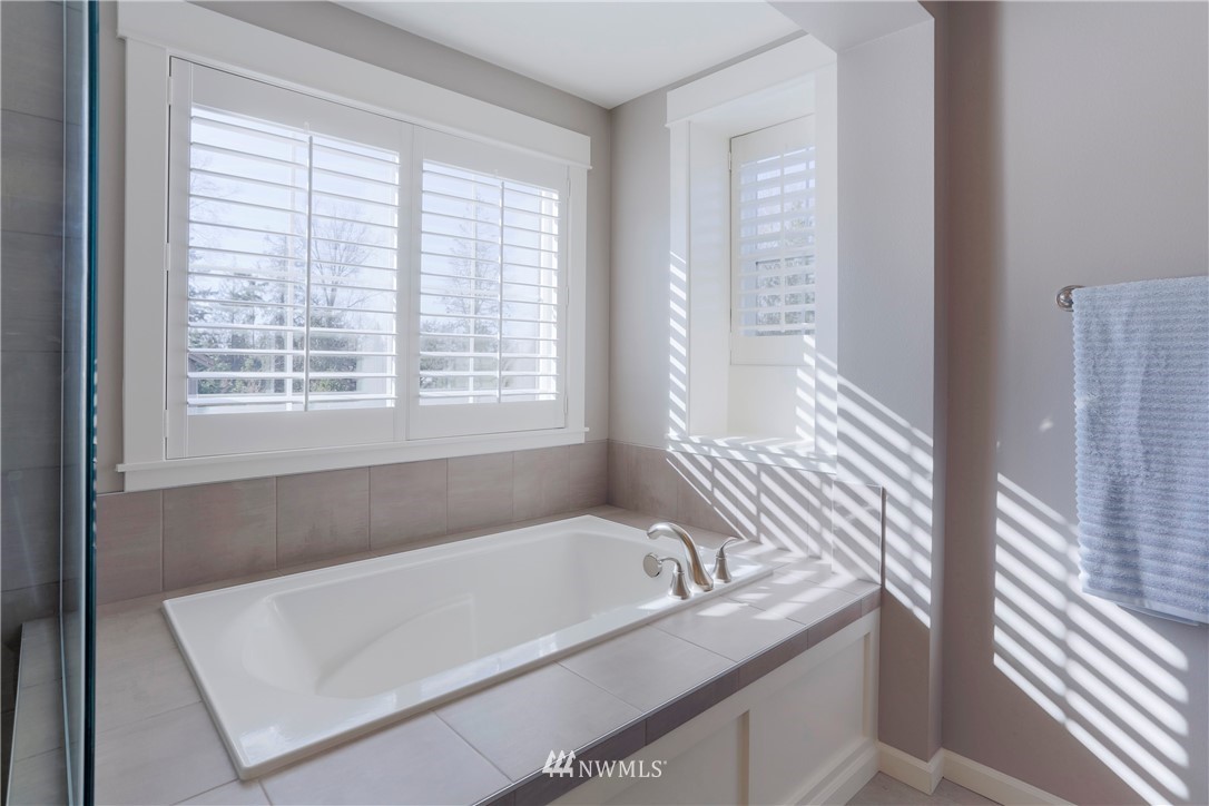 762 Lyons Avenue Northeast Renton, WA 98059 - Photo 22 of 33 a bath tub sitting in a bathroom next to a window