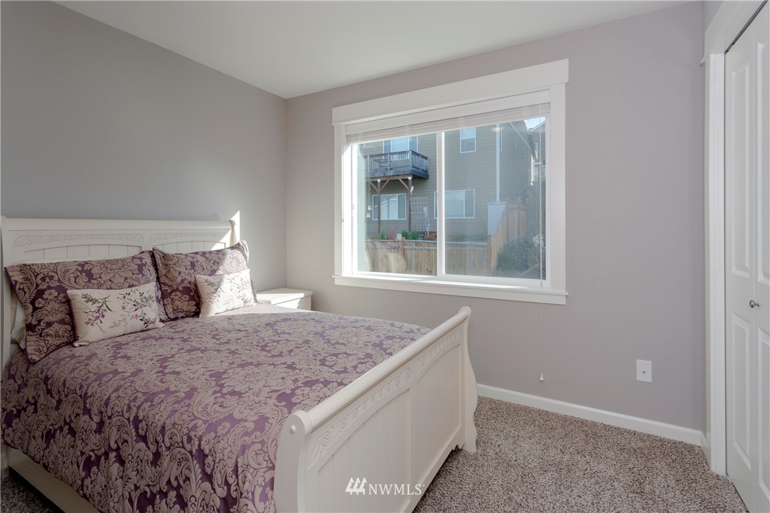 762 Lyons Avenue Northeast Renton, WA 98059 - Photo 25 of 33 a bed sitting in a bedroom next to a window