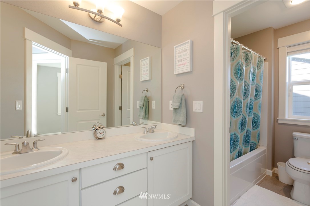 762 Lyons Avenue Northeast Renton, WA 98059 - Photo 26 of 33 a bathroom with a double vanity sink and a mirror