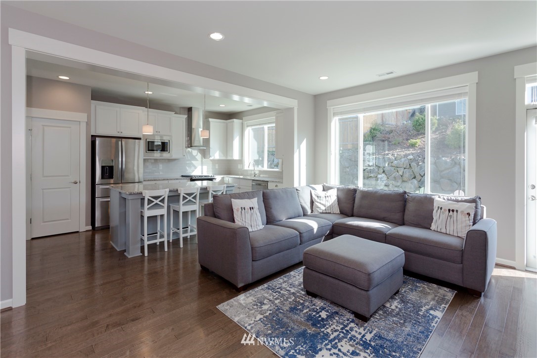 762 Lyons Avenue Northeast Renton, WA 98059 - Photo 5 of 33 a living room with furniture and a large window with kitchen view