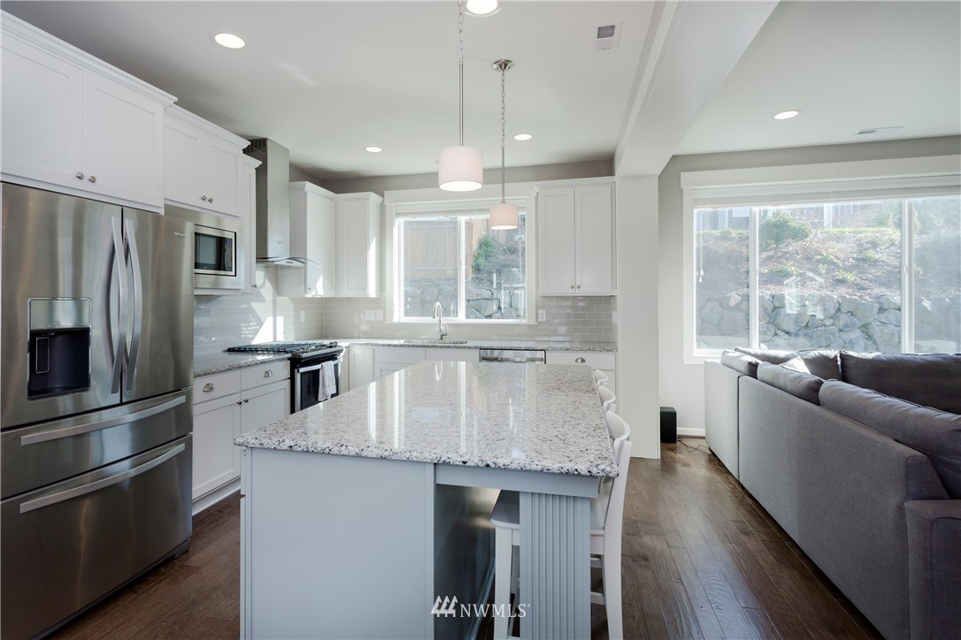 762 Lyons Avenue Northeast Renton, WA 98059 - Photo 7 of 33 a kitchen with stainless steel appliances granite countertop a sink a stove and a refrigerator
