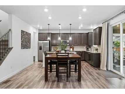 a kitchen with kitchen island granite countertop a counter space a sink appliances and cabinets
