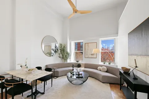 a living room with furniture flowerpot and window