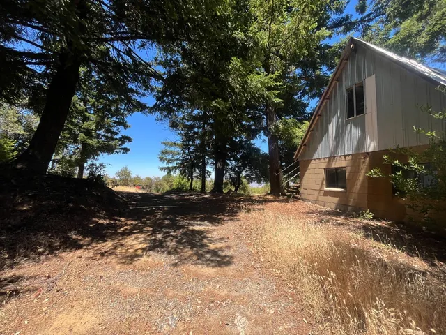 a view of a house with a tree in the background