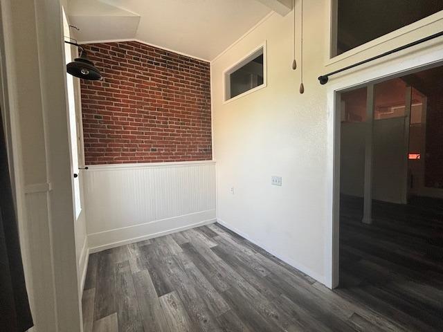 a view of a small space with wooden floor and a window