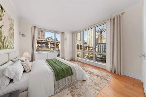a bedroom with a large bed and a large window