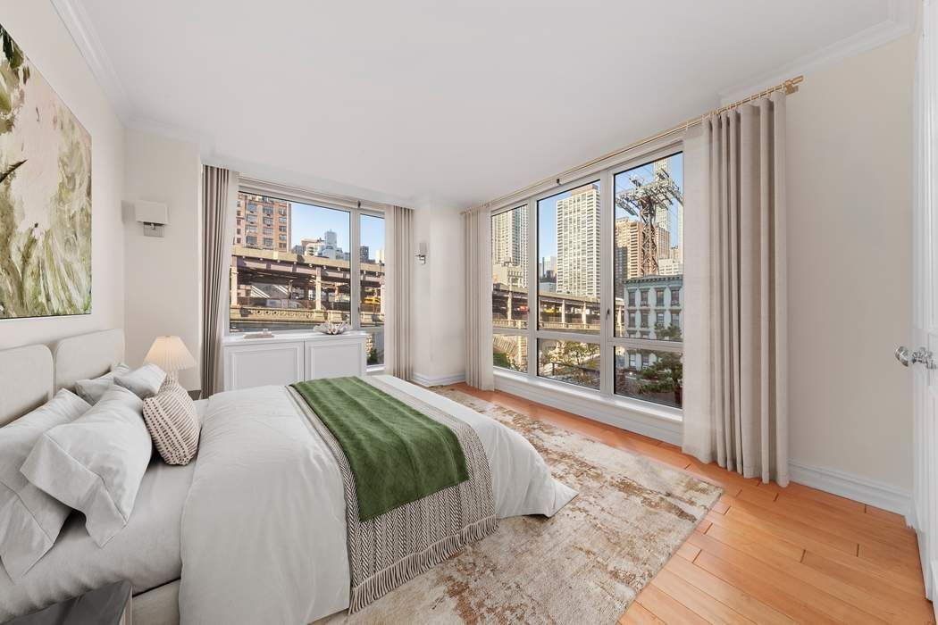401 East 60th Street, Unit 4C Manhattan, NY 10022 - Photo 12 of 28 a bedroom with a large bed and a large window