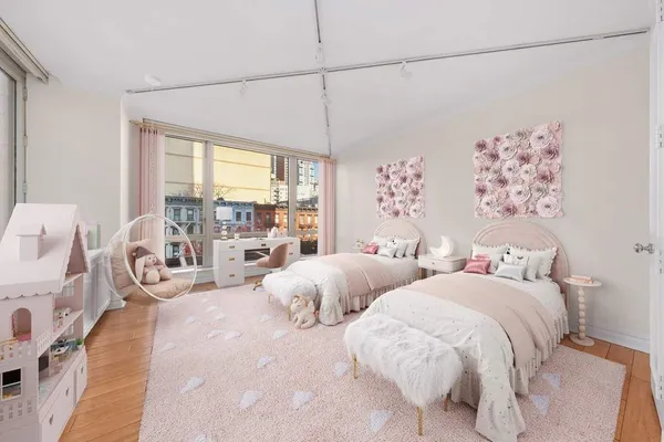 a bedroom with two beds and large window