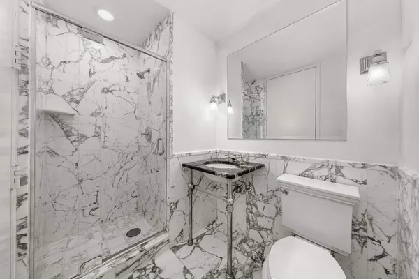 a bathroom with a sink toilet and shower