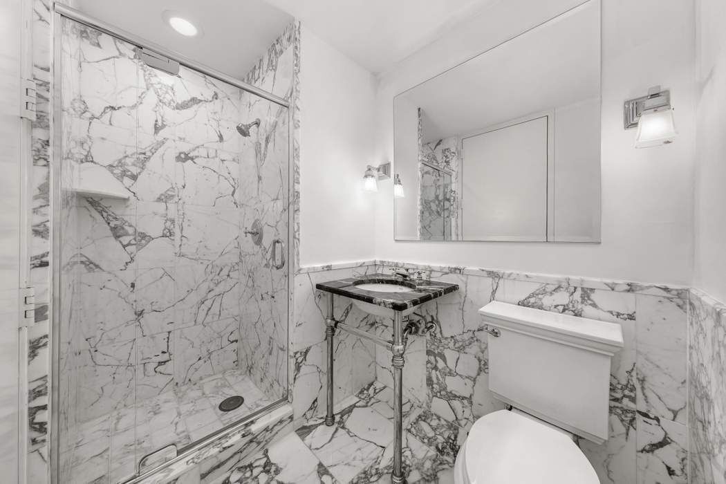 401 East 60th Street, Unit 4C Manhattan, NY 10022 - Photo 16 of 28 a bathroom with a sink toilet and shower