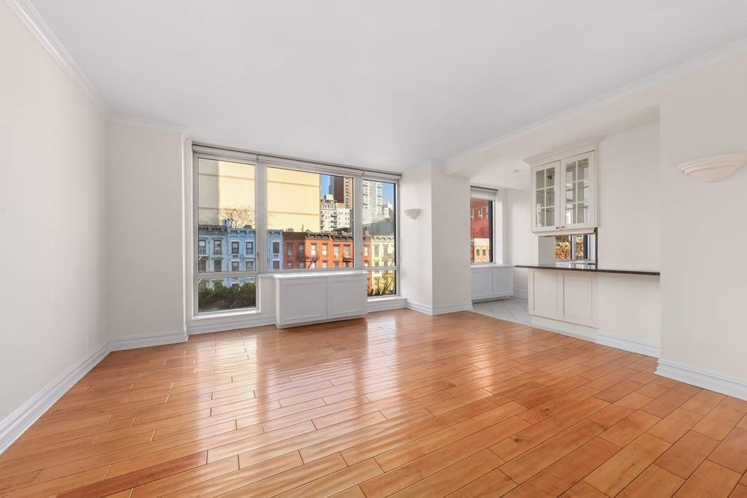 401 East 60th Street, Unit 4C Manhattan, NY 10022 - Photo 22 of 28 a view of a room with wooden floor and a window