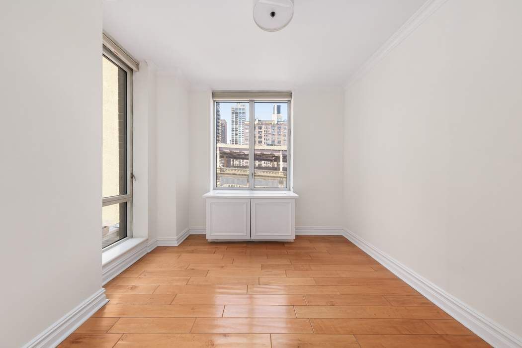 401 East 60th Street, Unit 4C Manhattan, NY 10022 - Photo 24 of 28 a view of an empty room with a window