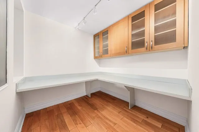 a hallway with cabinet and a window