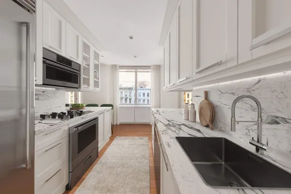 a kitchen with stainless steel appliances granite countertop a sink stove and microwave