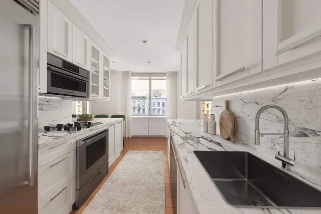 a kitchen with stainless steel appliances granite countertop a sink stove and microwave