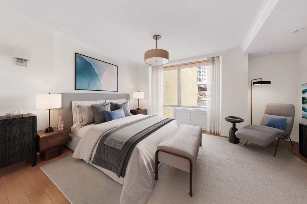401 East 60th Street, Unit 4C Manhattan, NY 10022 - Photo 7 of 28 a bedroom with a bed and a chandelier