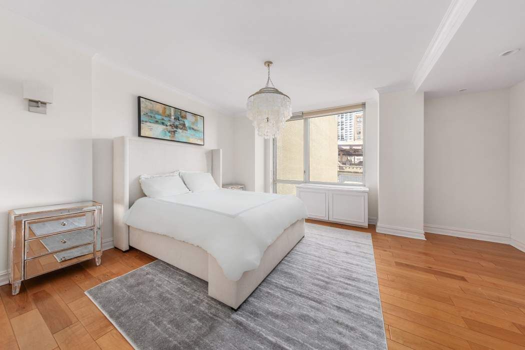 401 East 60th Street, Unit 4C Manhattan, NY 10022 - Photo 8 of 28 a bedroom with a bed and a window