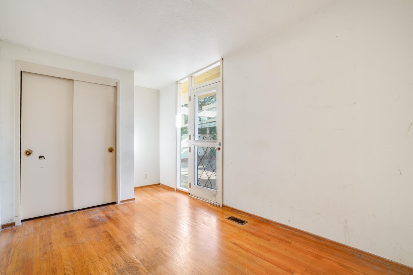 266 Thompson Avenue Mountain View, CA 94043 - Photo 19 of 25 a view of an empty room with wooden floor