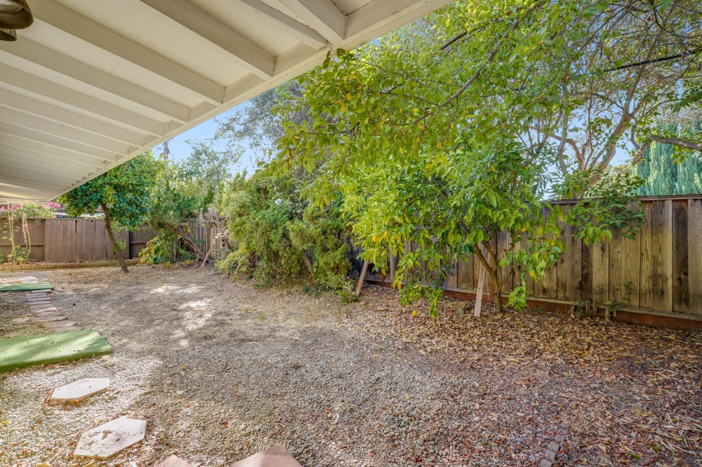 266 Thompson Avenue Mountain View, CA 94043 - Photo 21 of 25 a view of a backyard with large trees and wooden fence