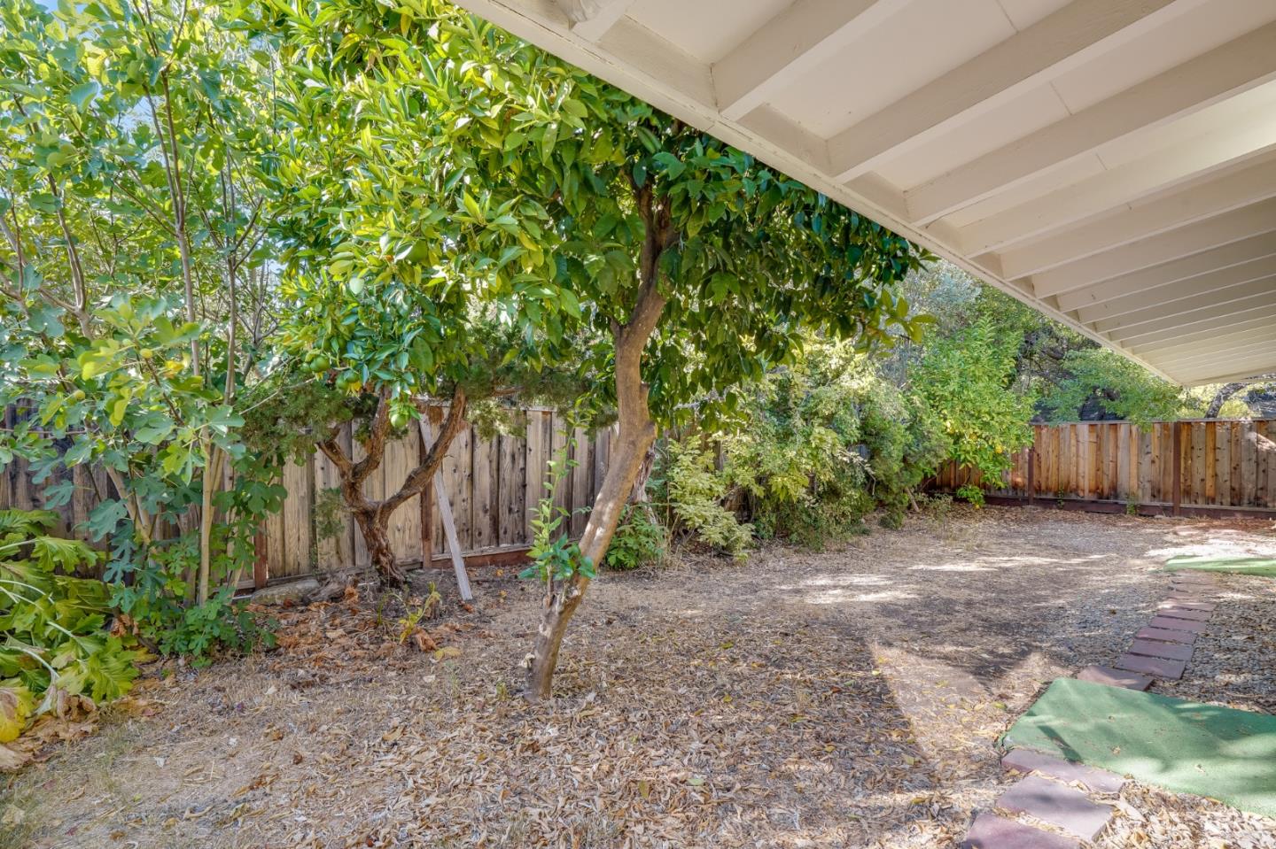 266 Thompson Avenue Mountain View, CA 94043 - Photo 25 of 25 a view of a backyard with large trees and wooden fence