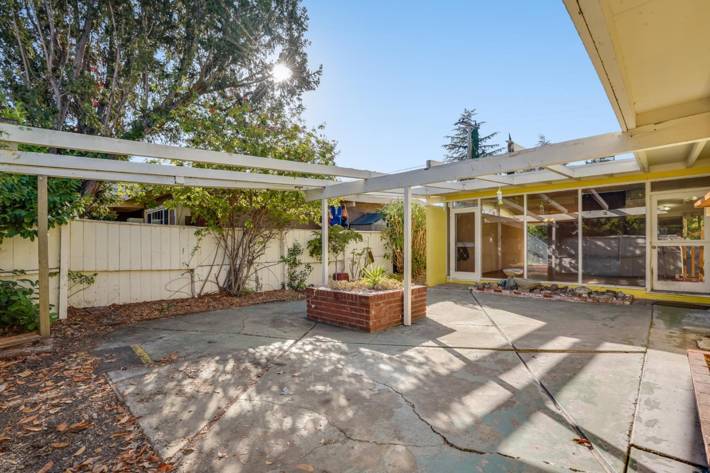 266 Thompson Avenue Mountain View, CA 94043 - Photo 4 of 25 a backyard of a house with a large tree and wooden fence