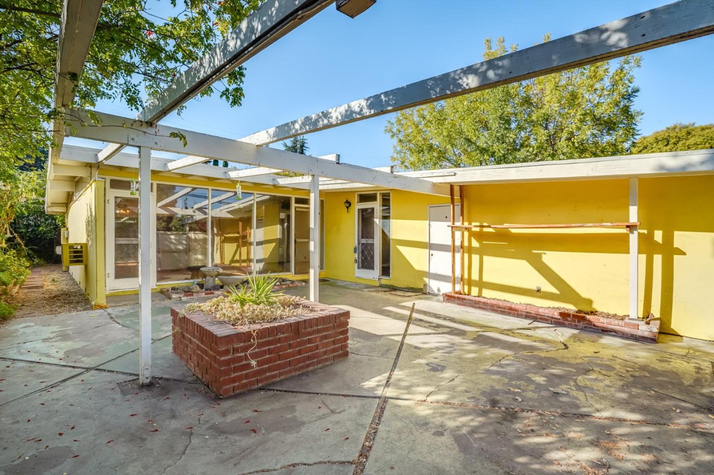 266 Thompson Avenue Mountain View, CA 94043 - Photo 6 of 25 a view of a patio with a table and chairs and potted plants