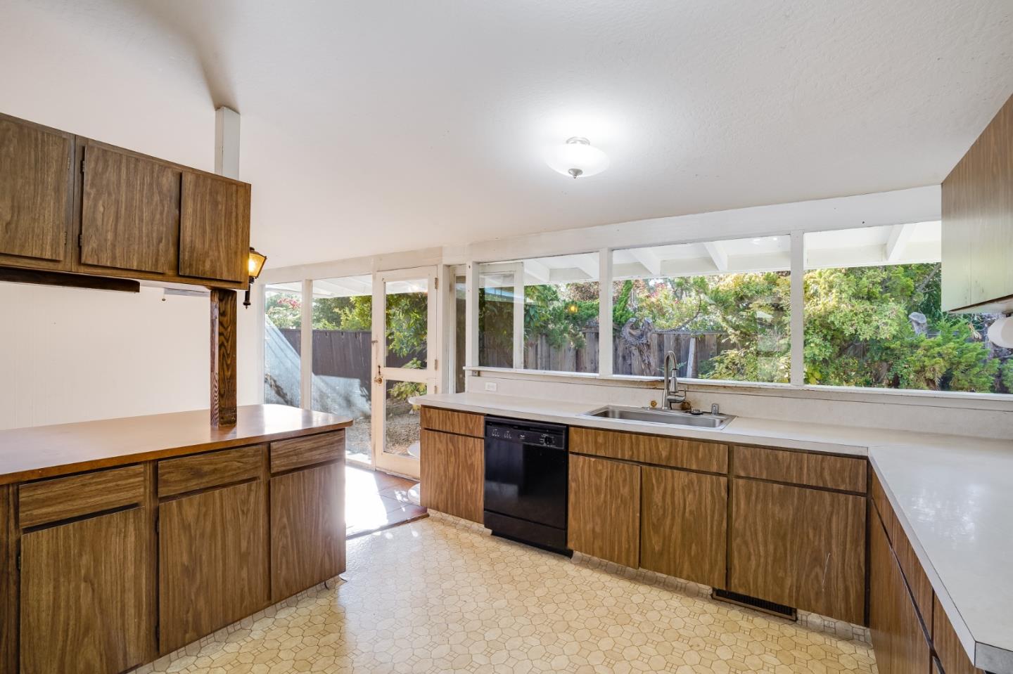 266 Thompson Avenue Mountain View, CA 94043 - Photo 9 of 25 a kitchen with a sink stove and cabinets