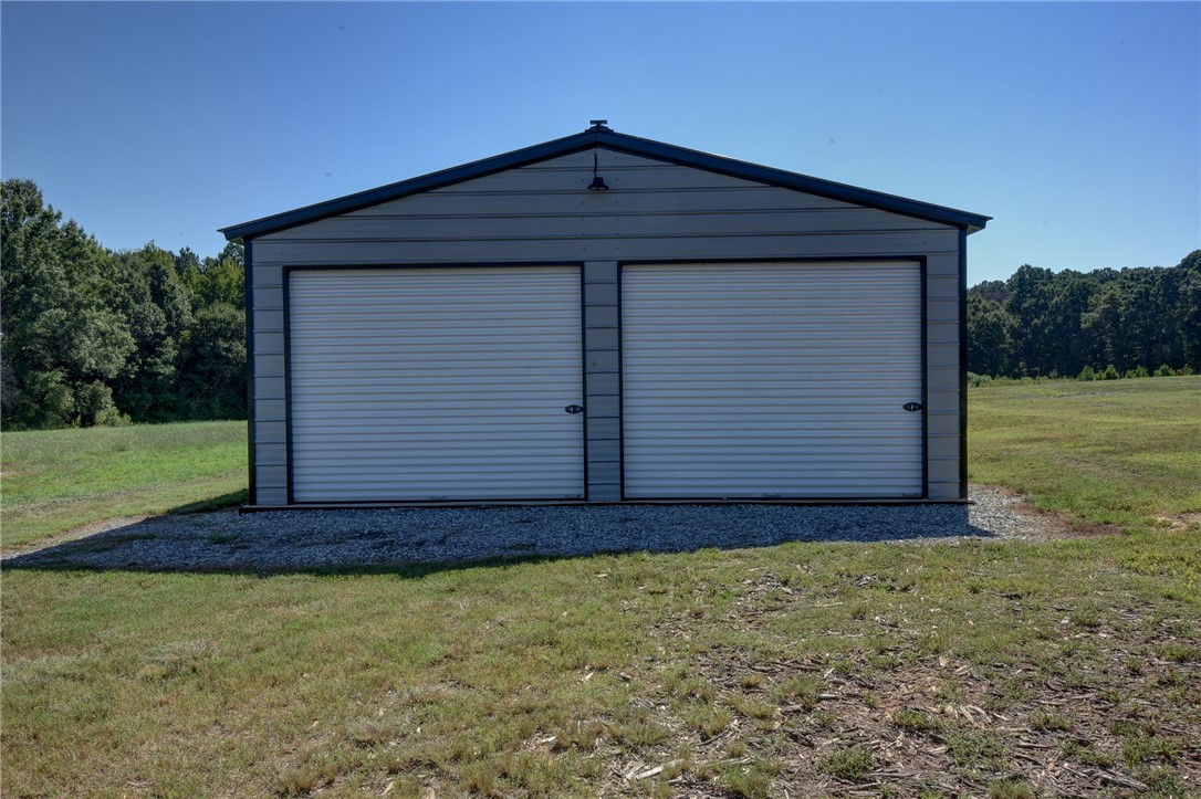 220 Clinkscales Road Anderson, SC 29624 - Photo 23 of 33 A spacious detached metal outbuilding provides ample storage space and utility on the property.