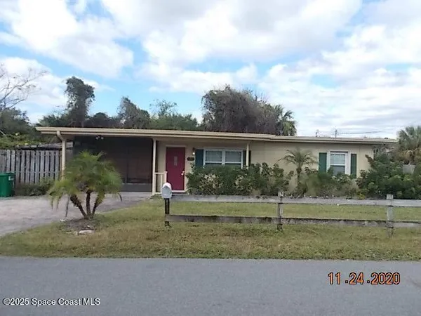 a view of a house with a yard and table