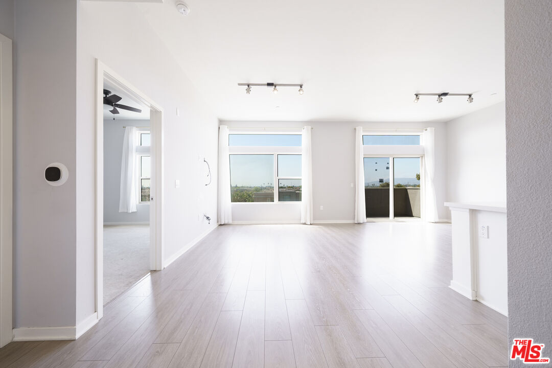 552 East Carson Street, Unit 408 Carson, CA 90745 - Photo 28 of 63 a view of an empty room with wooden floor and a window