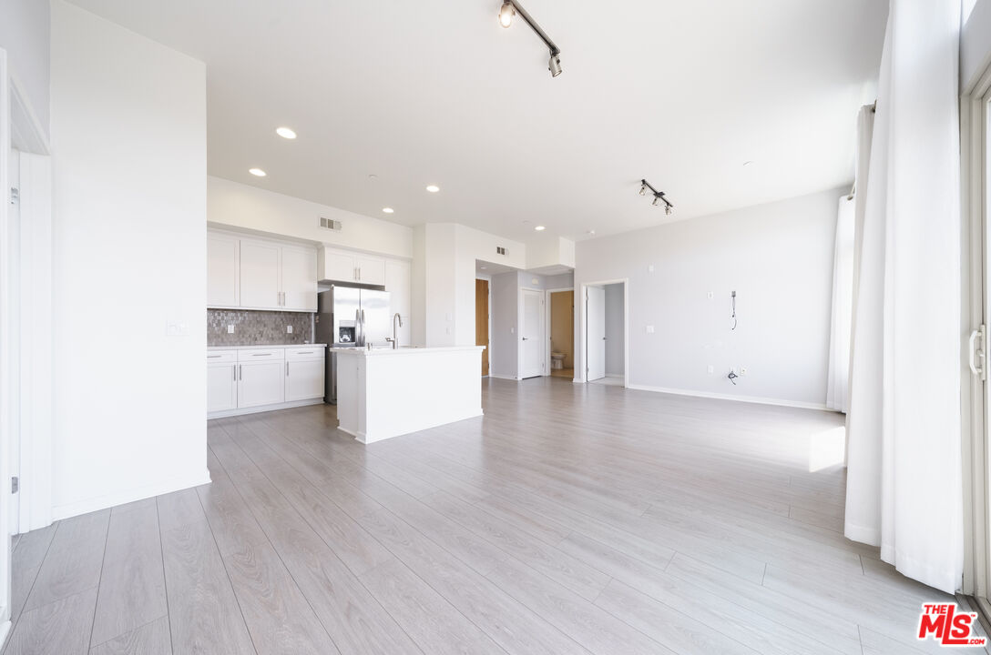 552 East Carson Street, Unit 408 Carson, CA 90745 - Photo 37 of 63 a view of a kitchen with a sink and wooden floor