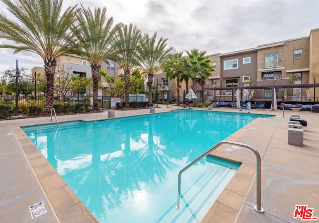 552 East Carson Street, Unit 408 Carson, CA 90745 - Photo 51 of 63 a view of a swimming pool with chairs and tables