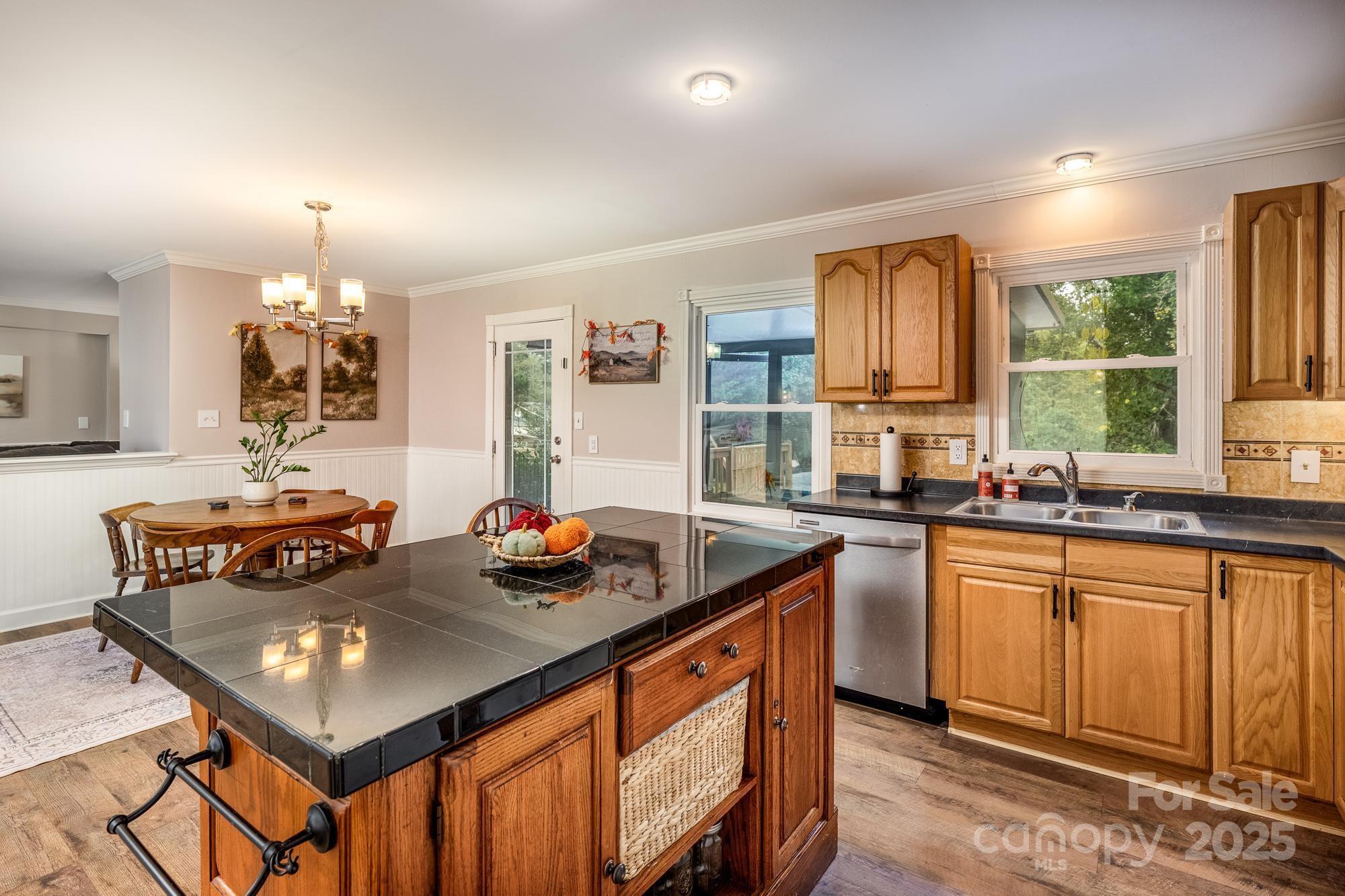 550 Brumley Road Mooresville, NC 28115 - Photo 11 of 35 a kitchen with stainless steel appliances granite countertop a stove a sink dishwasher and a refrigerator with wooden floor