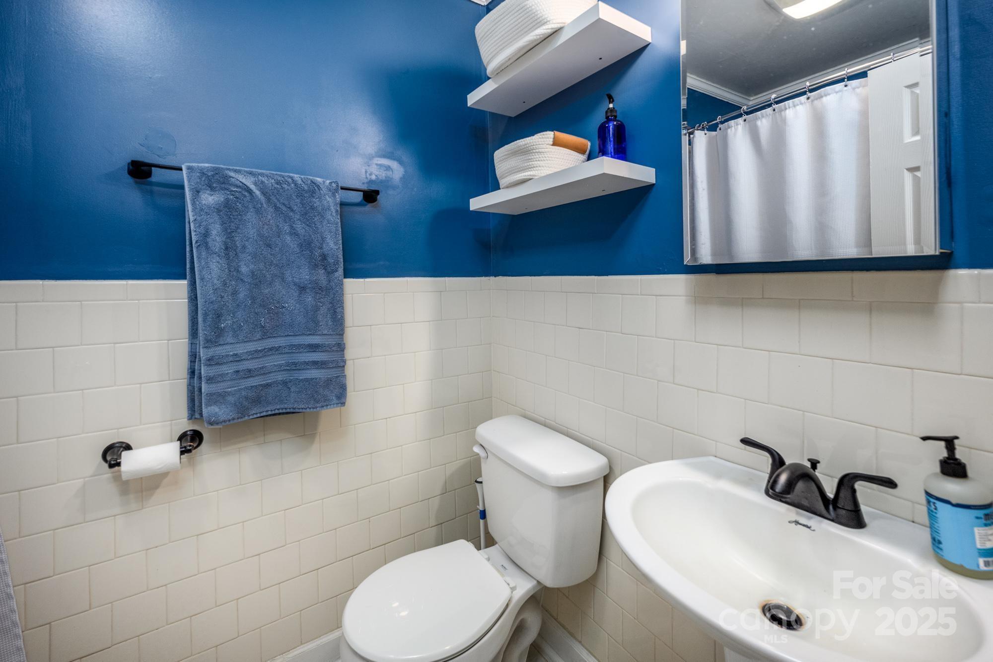 550 Brumley Road Mooresville, NC 28115 - Photo 17 of 35 a bathroom with a sink a toilet and mirror