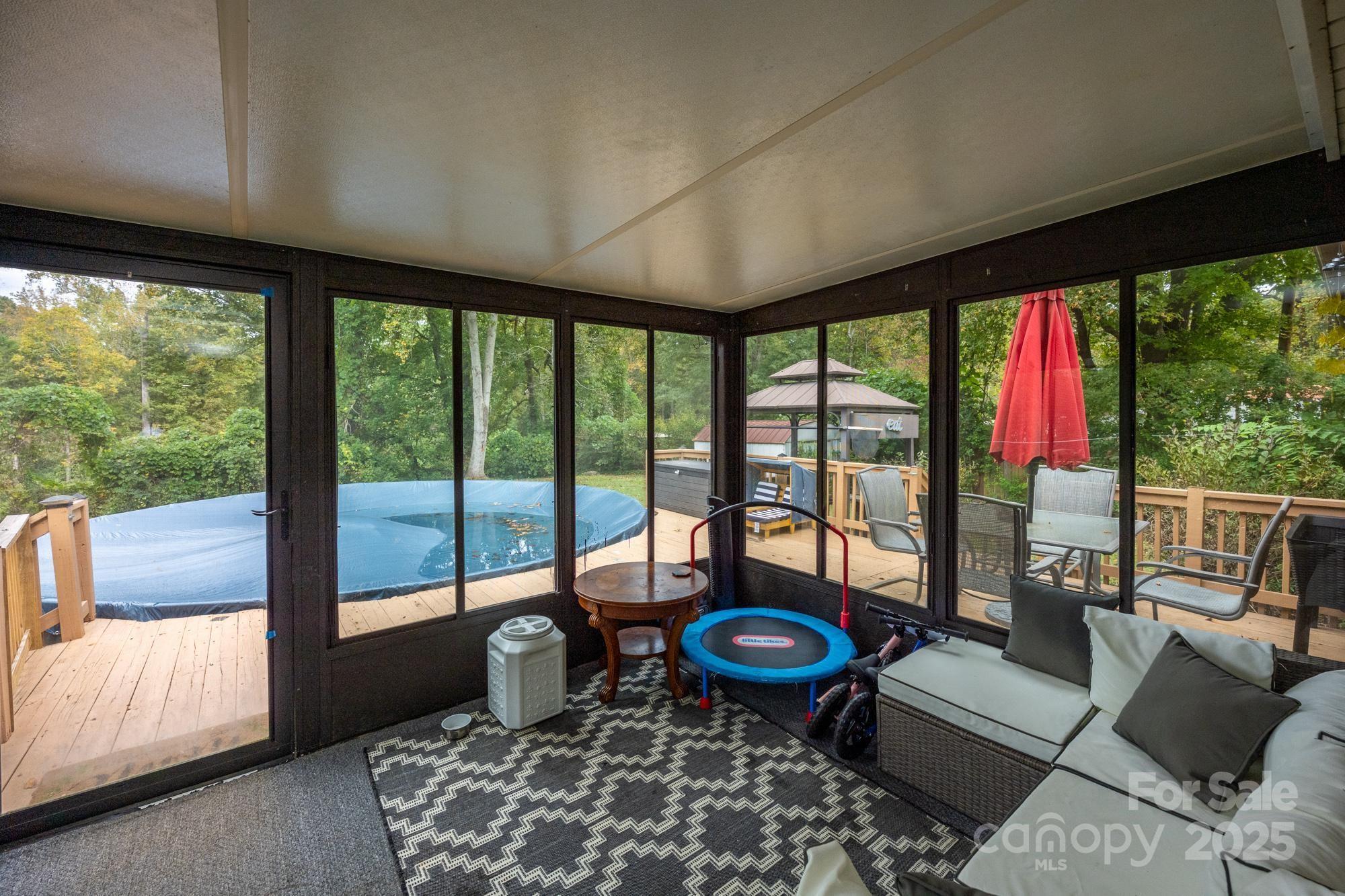 550 Brumley Road Mooresville, NC 28115 - Photo 24 of 35 a living room with furniture and a floor to ceiling window