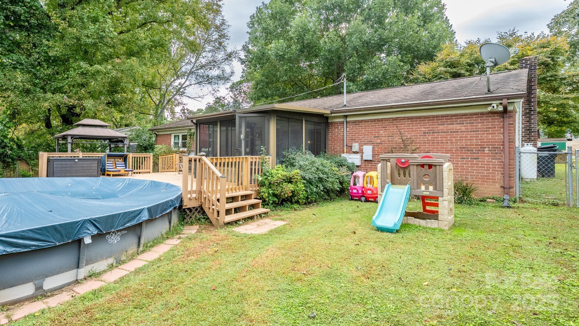 550 Brumley Road Mooresville, NC 28115 - Photo 27 of 35 a view of a patio with table and chairs under an umbrella