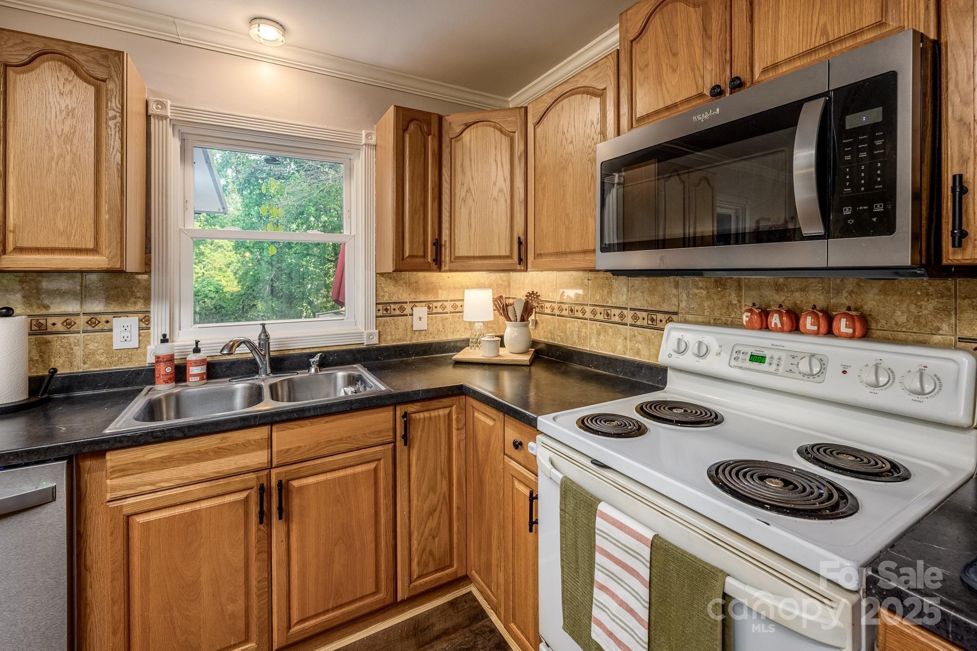 550 Brumley Road Mooresville, NC 28115 - Photo 10 of 35 a kitchen with a stove a sink and a microwave
