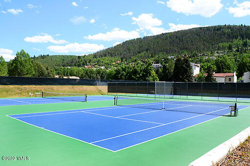 346 Eagle Road, Unit 2 Avon, CO 81620 - Photo 18 of 25 a view of tennis court with houses in the background