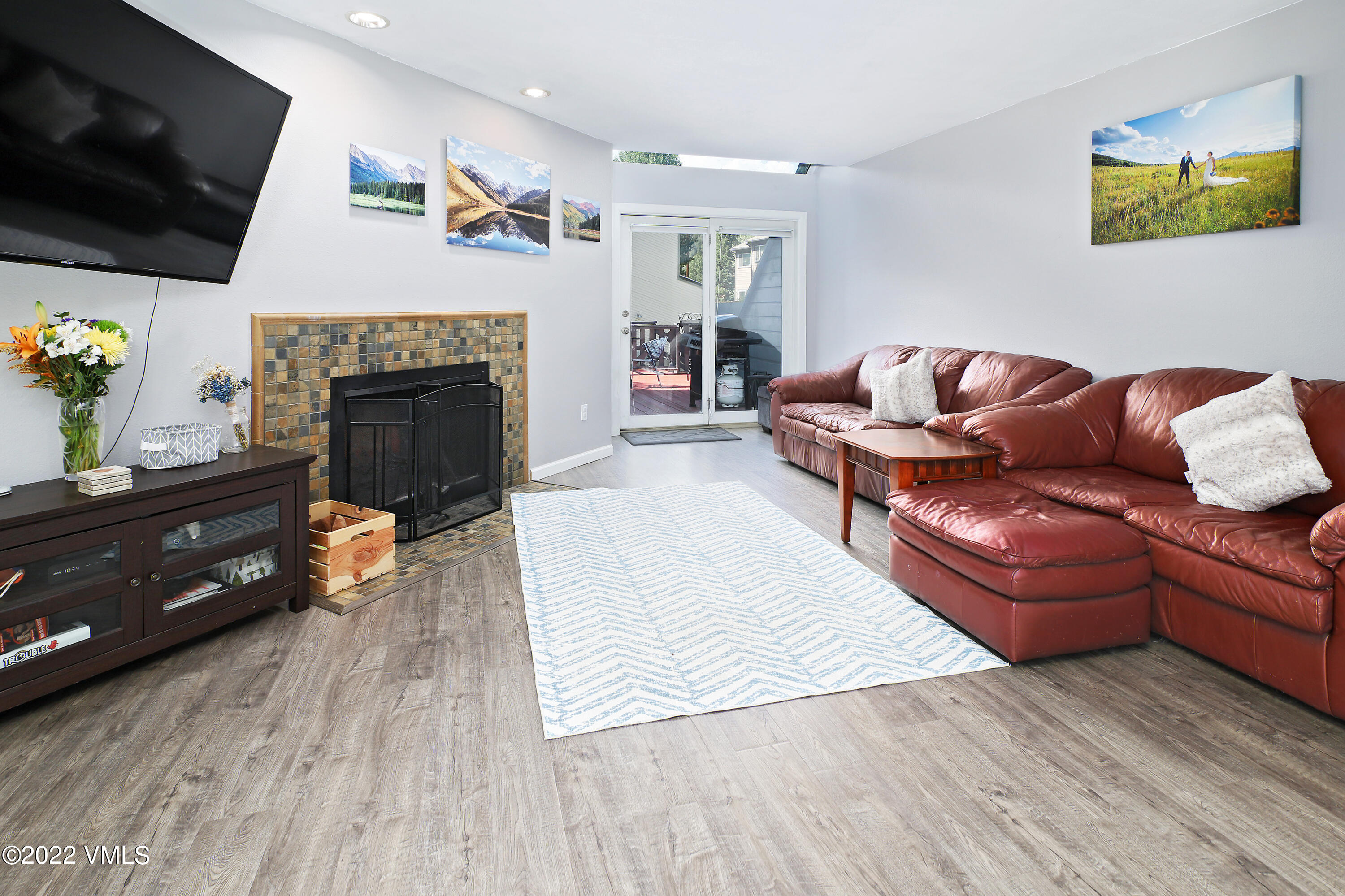 346 Eagle Road, Unit 2 Avon, CO 81620 - Photo 2 of 25 a living room with furniture flat screen tv and a fireplace
